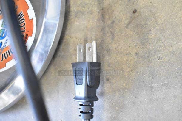 Ceado ES500 Juice Extractor power plug, 110-120V, with visible Juicom label on metal surface.