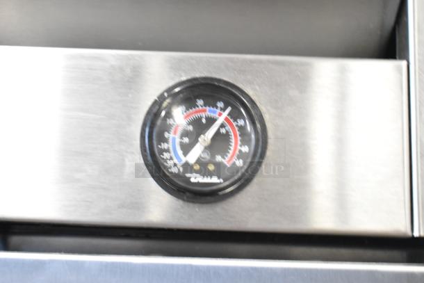 2016 True T-35 commercial cooler temperature gauge detail showing red and blue dials. Bright stainless steel surface.