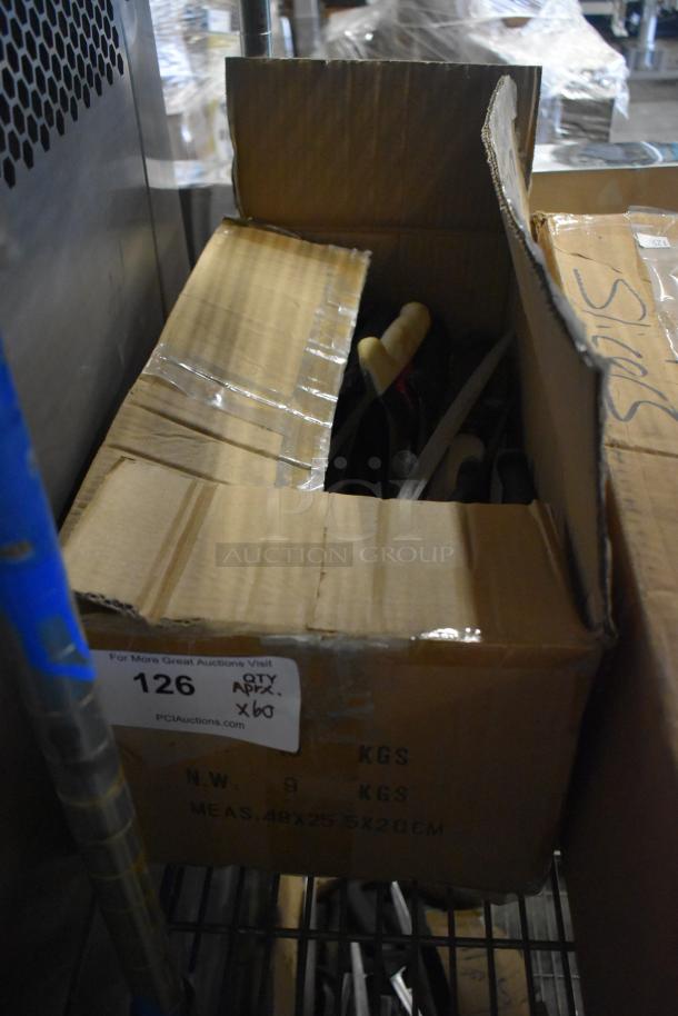 Cardboard box containing 60 sharpened stainless steel knives, including fillet knives. Box labeled "QTY APX x60."