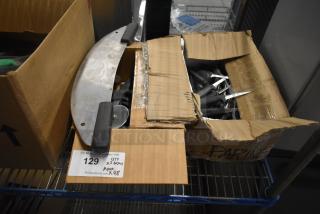 Two boxes containing sharpened stainless steel knives including paring knives, pizza cutters, and a dough cutter. Auction tag reads "QTY x 2 boxes APX x 48".