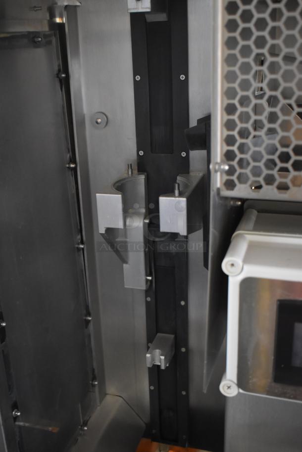 JBT 2ND-GEN-MFJ-HE commercial citrus juicer interior view, showcasing stainless steel components, in excellent condition.