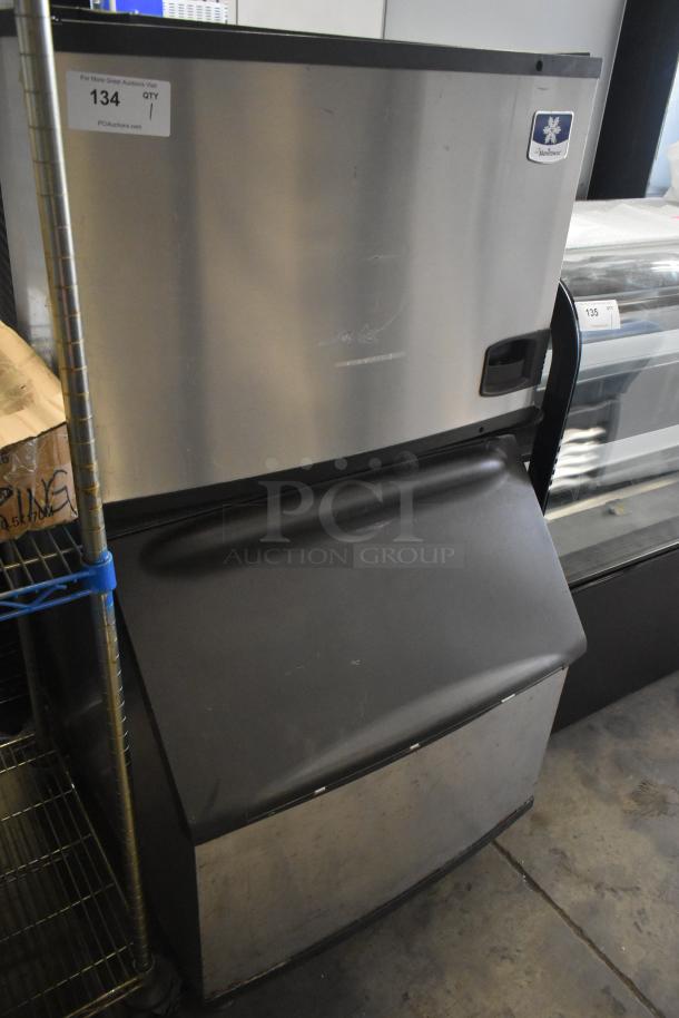 Manitowoc commercial ice head on bin, stainless steel, used condition, model label visible, auction item tag #134.