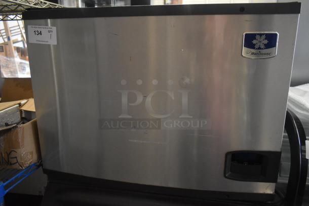 Manitowoc commercial ice head on bin, stainless steel, visible scratches, Manitowoc logo, auction tag number 134.