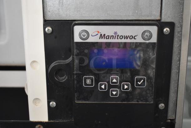 Manitowoc commercial ice head control panel on ice bin, features brand logo and control buttons, in used condition.