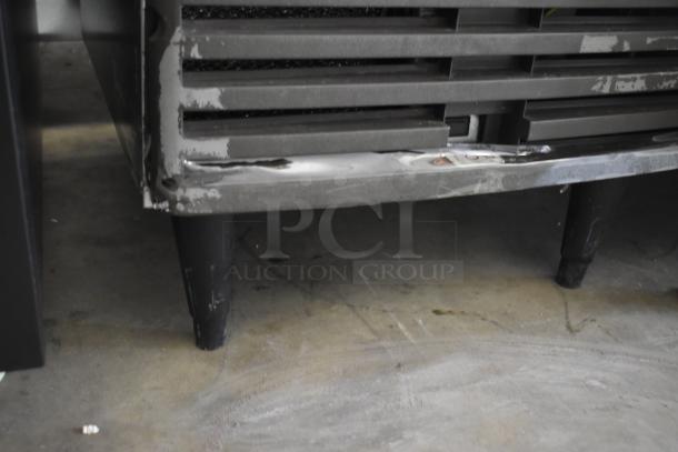 Manitowoc QM45A ice maker, undercounter model with visible wear and dents. 95 lbs/day capacity. 115 volts, 1 phase.