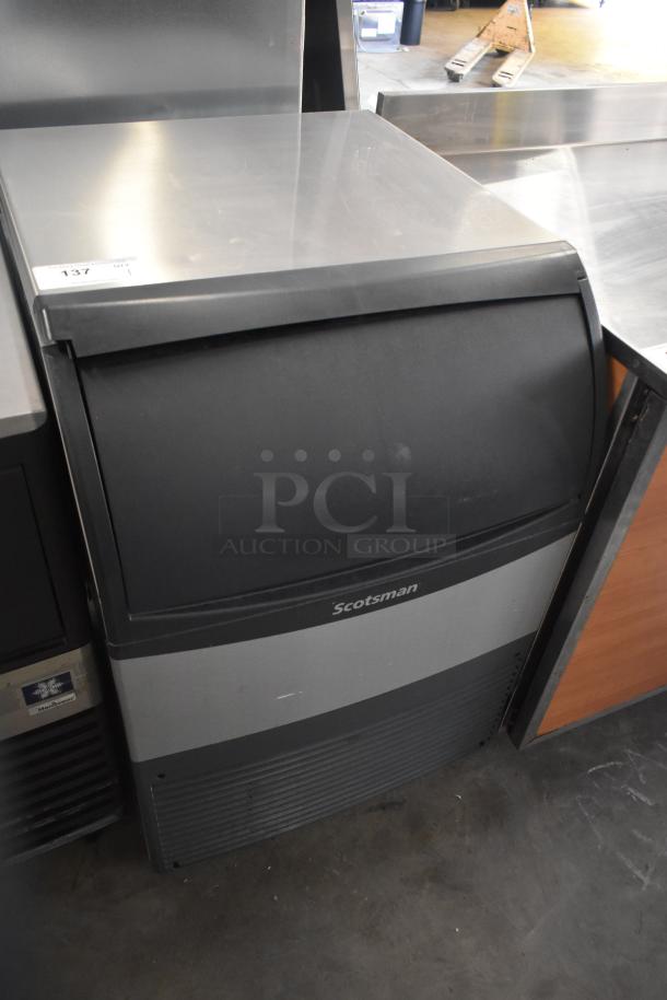 Scotsman commercial undercounter ice maker, stainless steel, used condition, visible brand logo, efficient for small spaces.