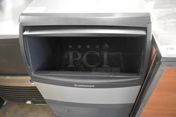 Scotsman commercial undercounter ice maker, self-contained, used condition, model details not visible, steel finish.
