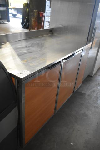 Duke RBC-60M commercial 3-door work top cooler, 120 volts, 1 phase. Stainless steel top, wood-finished doors.