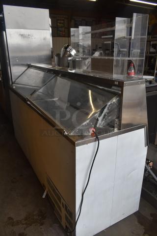 Master Bilt commercial ice cream dipping cabinet with stainless steel top, clear sliding lids, and attached power cord.