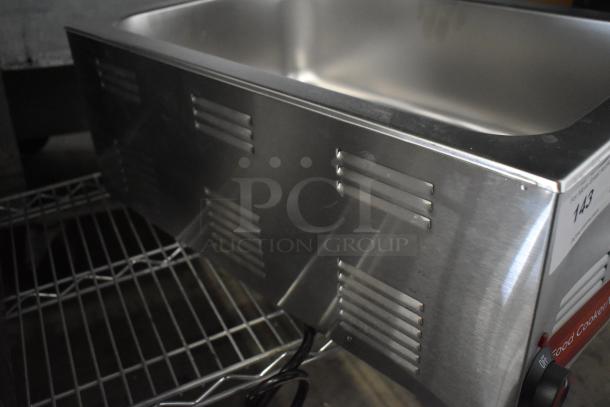 Brand new Avantco 177W50CKR 12" x 20" electric countertop food warmer. Stainless steel, 120 volts, with slight cosmetic dent.