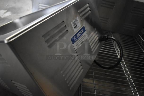 Brand new Avantco 177W50CKR 12"x20" electric countertop food warmer. Visible construction details and power cord.