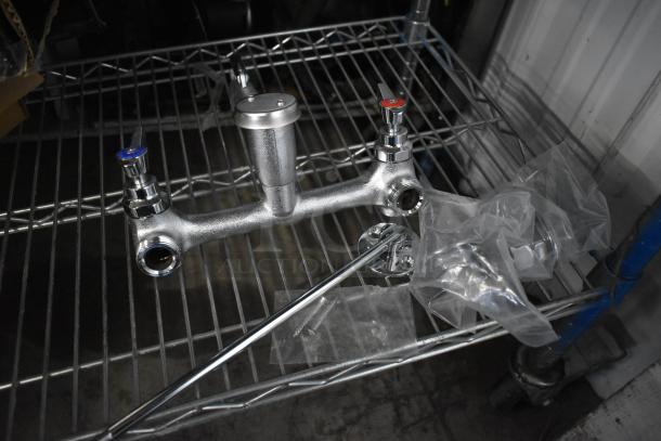 Brand new Regency 600FMS86 wall-mounted mop sink faucet with 6.5" spout, 8" centers, and vacuum breaker. Scratch and dent.