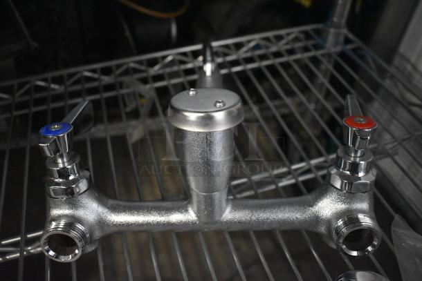 Brand new Regency 600FMS86 wall-mounted mop sink faucet with 6.5" spout, 8" centers, and vacuum breaker.