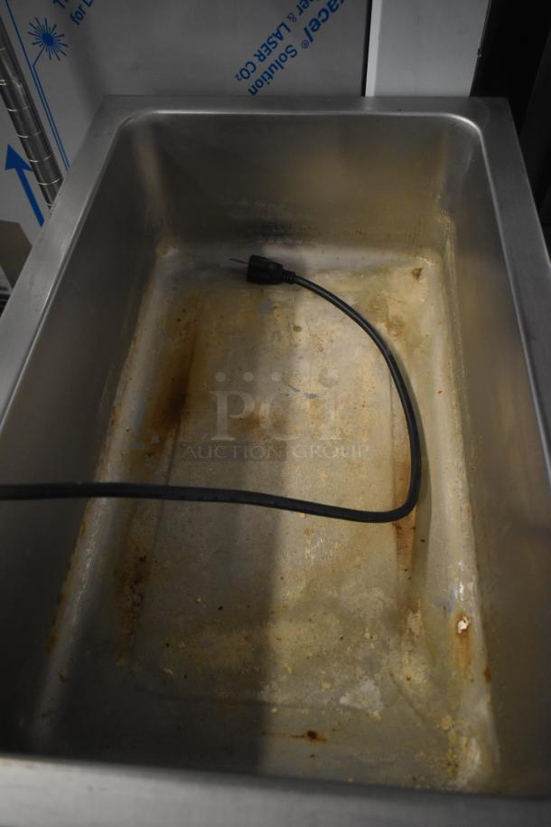 Winco FW-S500 commercial food warmer, countertop model. Used condition with visible wear and attached power cord. 120 Volts, 1 Phase.