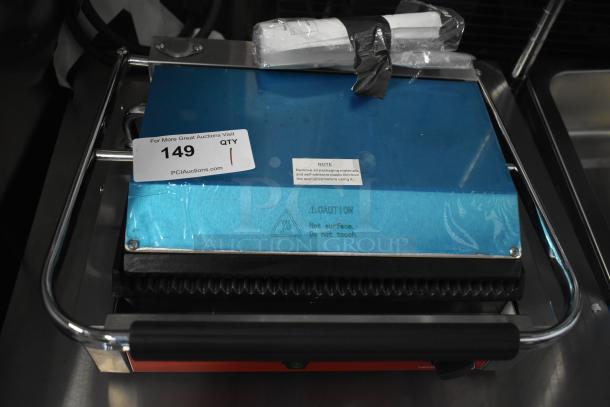 Brand new Avantco 177PG200 Panini Grill with grooved plates, 13 3/8" x 8 3/4" cooking surface, tagged "149 QTY 1".