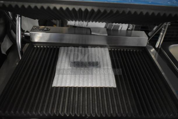 Avantco 177PG200 Panini Grill, new, grooved plates, 13 3/8" x 8 3/4" surface, 120V, 1 phase, protective foam insert.