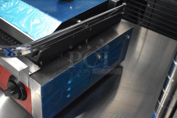 Brand new Avantco 177PG200 panini grill with grooved plates, 13 3/8" x 8 3/4" cooking surface, 120V, minor scratches.