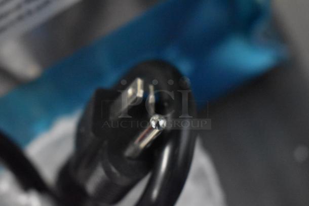 Close-up of a power plug for the Avantco 177PG200 Panini Grill, showing the prongs, indicative of its new condition.