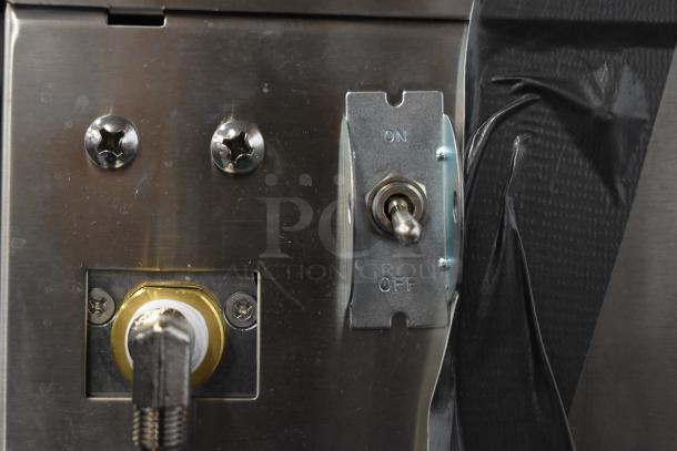 Close-up of control panel on Curtis D60GT12A000 Low Profile Thermal Carafe Coffee Brewer, showing on/off switch and screws.