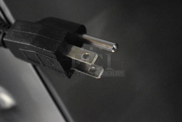 Close-up of Curtis D60GT12A000 coffee brewer power plug, 120 volts, showing prongs and cable condition.