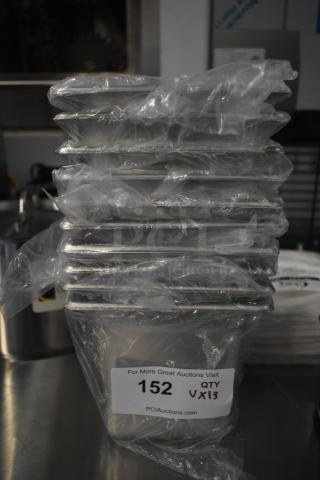 Stack of 13 brand new scratch and dent kitchen items, wrapped in plastic, with auction tag showing "152 QTY 13".