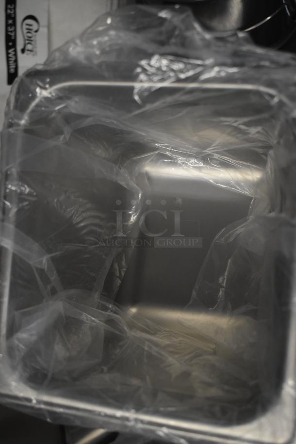 13 brand new scratch and dent items including a drop-in bin wrapped in plastic, showcasing new condition.