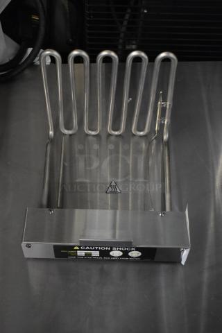 Brand new fryer burner, stainless steel, with minor scratches and dents. "Caution Shock" label present, includes wiring.