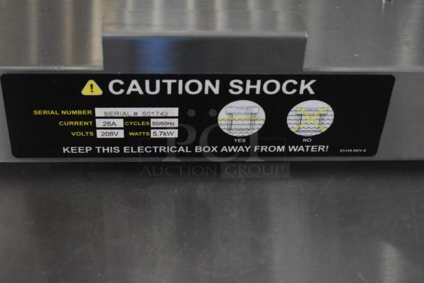 "Fryer burner with caution label, serial #501743, 28A, 208V, 5.7kW. 'Keep away from water' warning visible."