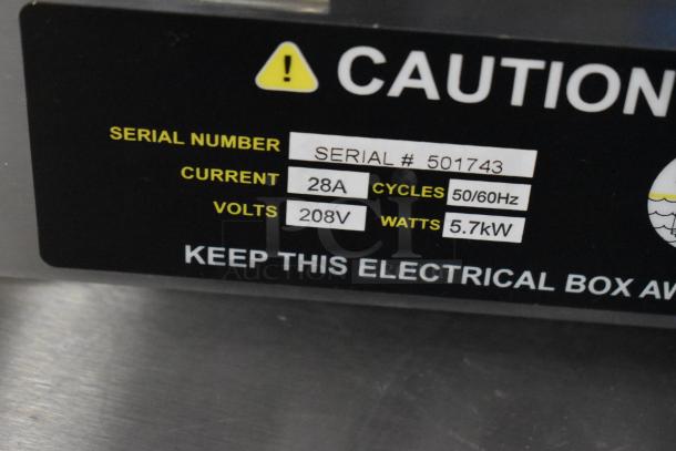 "Fryer burner label showing caution sign, serial number 501743, 28A current, 208V, 50/60Hz cycles, and 5.7kW power."