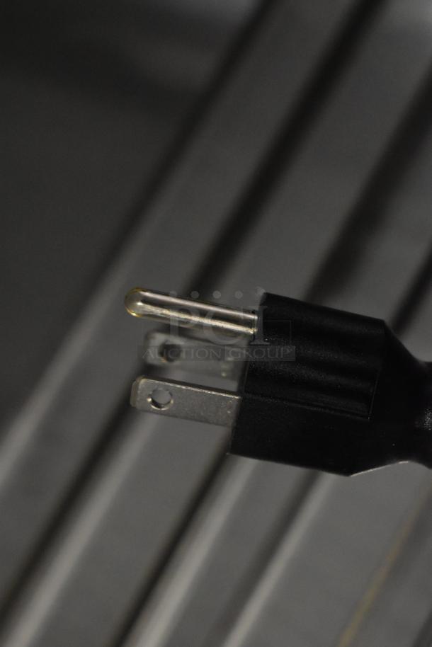 Close-up of a power plug connected to the Avantco 178APT60MHC Commercial Prep Table, showing 115 volts compatibility.