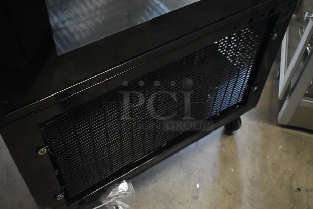 Brand new Avantco 193GD4C15HCB black 4-sided glass refrigerated display case. Features commercial casters. 110-120V, 1 Phase.