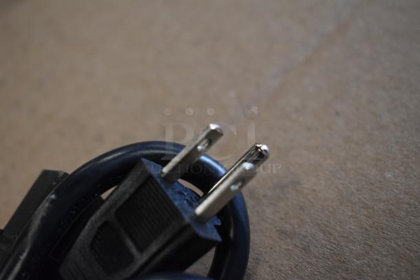 Close-up of a power cord plug for Carnival King 382HPWR18D2 pizza display warmer, showing two prongs.