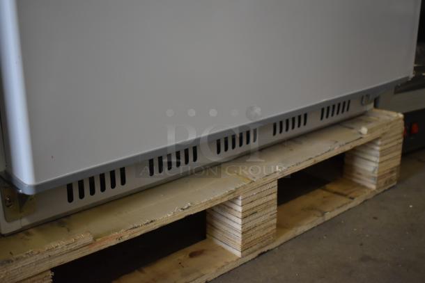 Brand new Arctic Air AWR25Z white refrigerator, 25 cu. ft., 120V, shown on a pallet. Scratch and dent condition.