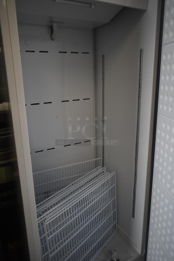 Brand new Arctic Air AWR25Z refrigerator, 25 cu. ft., single door, scratch and dent condition, interior view with shelves.