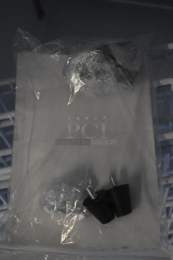 Bag of refrigerator accessories for Arctic Air AWR25Z, including bolts and parts, sealed in plastic.