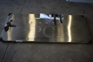 Metro Super Erecta Hot HS2460 stainless steel heated shelf, 24"x60", 120V, new with dents, visible packaging tape.