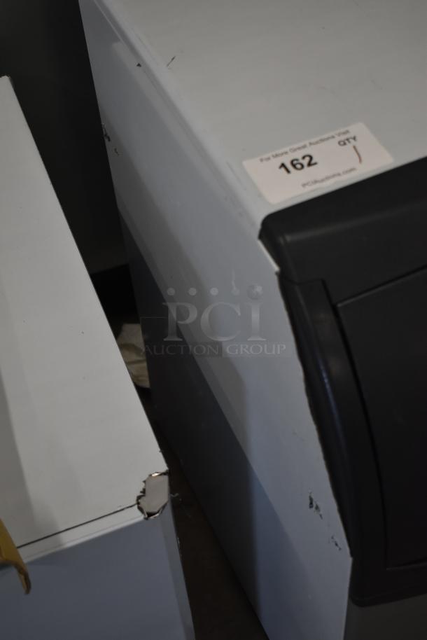 Brand new Scotsman CU0415MA-1A ice machine, 58 lb. capacity, slight dents visible, 115V, 1 phase, tag displays auction info.