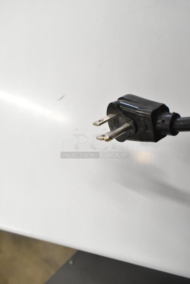 Power plug of the Scotsman CU0415MA-1A ice machine, showing standard 115V plug design.