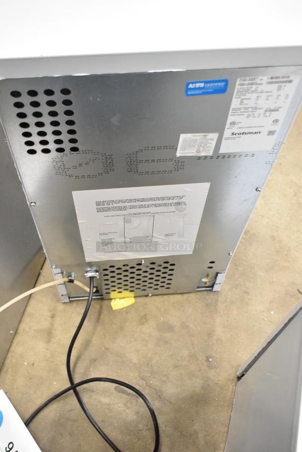 BRAND NEW Scotsman CU0415MA-1A ice machine, undercounter model, medium cube, 58 lb capacity, 115V, 1 Phase, rear view tags visible.