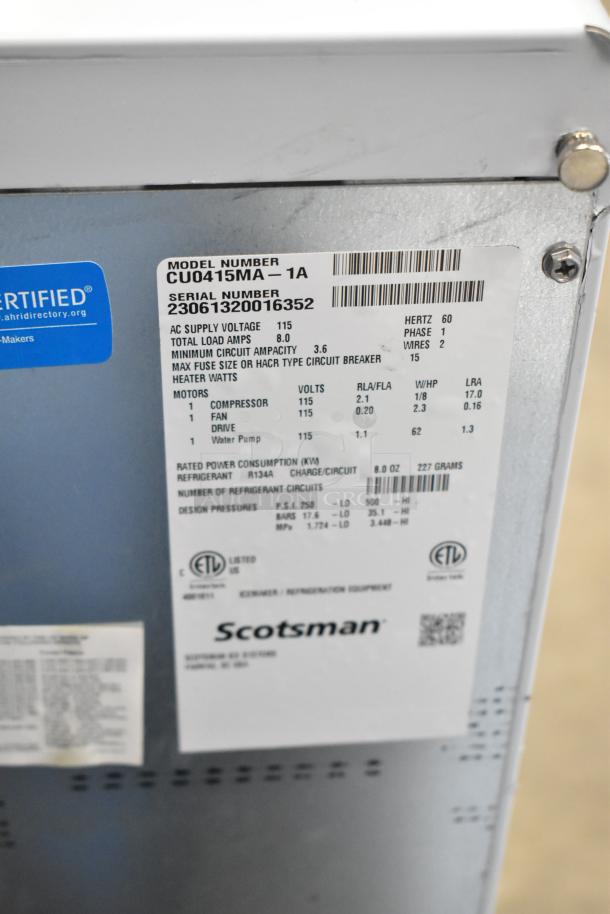 Brand new 2023 Scotsman CU0415MA-1A ice machine, undercounter, medium cube, 58 lb. capacity, 115 volts, 1 phase, scratch and dent. Visible labels show model, serial number, and technical specs.
