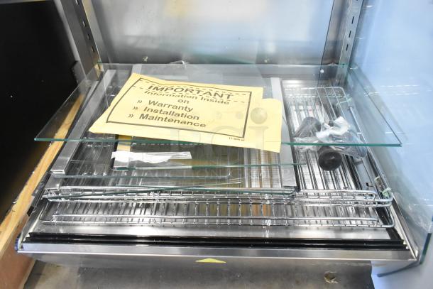 ServIt 423HDM26SA 26" heated display case with sliding doors. New, scratch and dent. Includes warranty info and installation guide. 120V.