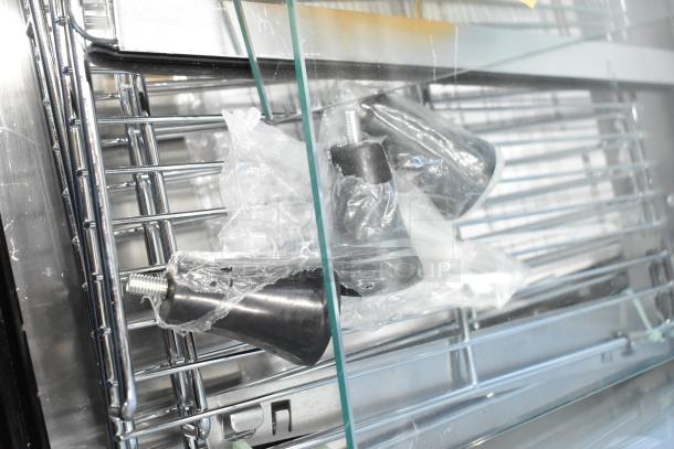 Brand new ServIt 423HDM26SA 26" heated display case. Includes 3 shelves, sliding doors. Scratch and dent condition visible.