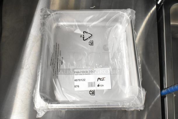 Pan food tray wrapped in plastic, labeled "PAN FOOD 2/3-2" ANTI-JAM 24 GAUGE". Scratch and dent inventory.
