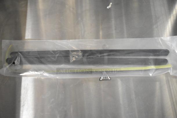 Plastic-wrapped kitchen utensil featuring two black metal rods and a yellow strap. Part of a 32-piece scratch and dent lot.