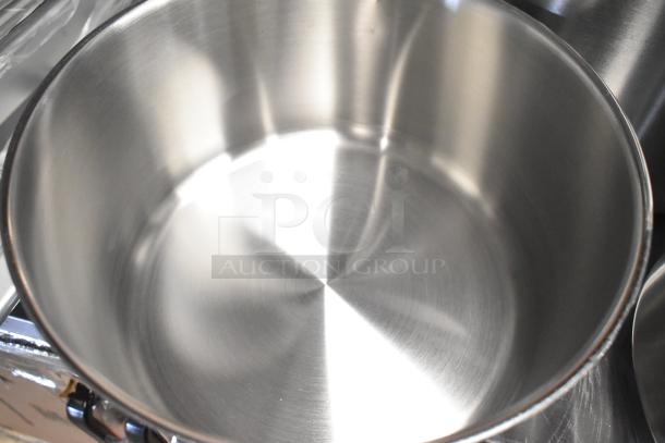 Brand new stainless steel pot, part of a 32-item scratch and dent lot, including strainers, colander, muffin pan.
