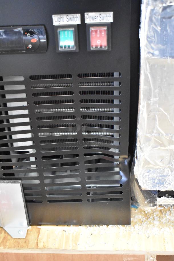 Brand new Avantco 178UBB72GHC bar refrigerator with LED lighting, light and power switches visible, broken glass on door.