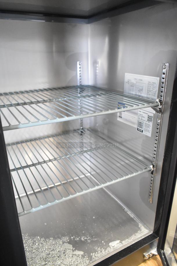 Brand new Avantco 73" back bar refrigerator, model 178UBB72GHC. Features LED lighting, black finish. Note: broken glass on door.