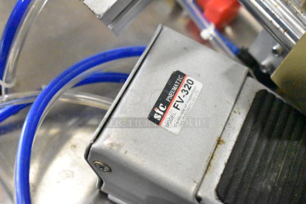 Countertop meat mixer with SIC FV-320 pneumatic food pedal, visible wear, clear and blue tubing, inspection certificate label.