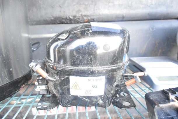 Brand new scratch and dent Cubigel NUT70NR compressor for Avantco models. Label includes model info and safety warning.