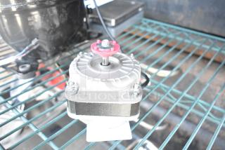 Brand new Avantco 17810032 fan motor, scratch and dent condition, visible mounting hardware, compact design.